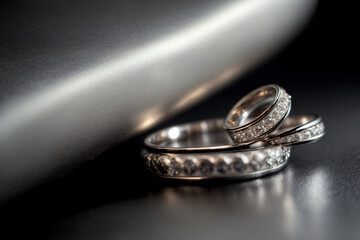 A Couple Of Wedding Rings Sitting On Top Of A Table