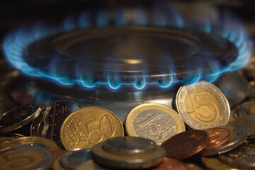 Flame from a gas burner, on the background of coins