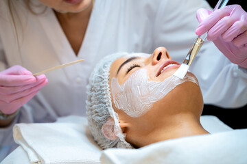 Cosmetology procedures for young woman in aesthetic clinic.