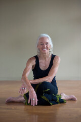 Portrait of a fit senior woman at a yoga studio. 