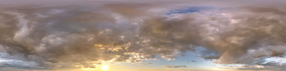 sunset skydome with evening clouds and rainbow as seamless hdri 360 panorama in spherical...