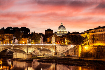 Fototapeta na wymiar Scenic view of the Vittorio Emanuele II Bridge across the Tiber and the dome of St. Peter's Cathedral in the Vatican at sunset. Rome, Italy