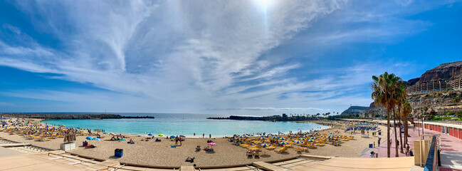 Panoramic photograph of Amadores beach in the southwest of Gran Canaria, calm waters and no waves...