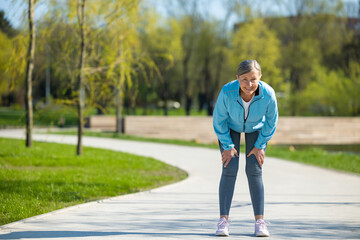 Woman in bluse sportswear doing stretching in the park