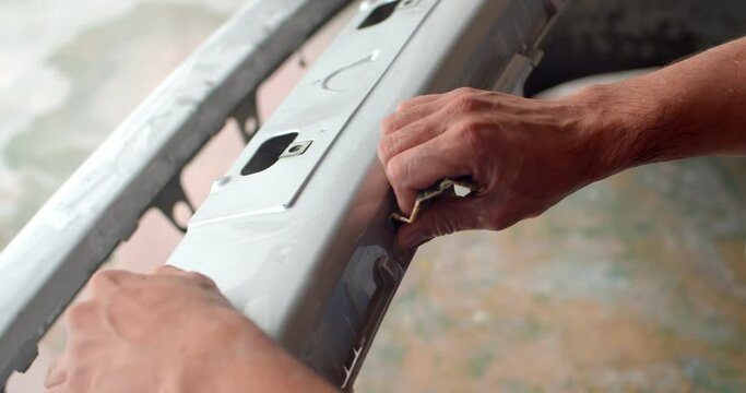 Polishing sandpaper with water to prepare the surface for further painting.