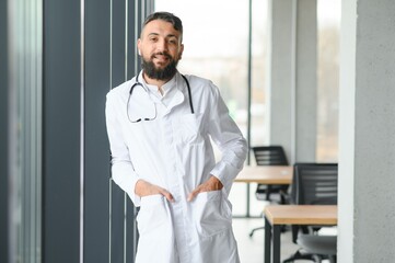 Portrait of a young arabian doctor standing in the the clinic