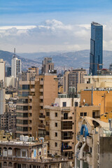 Fototapeta premium Beirut skyline showing the tallest building in the city, Sama Beirut, with mountains in the background