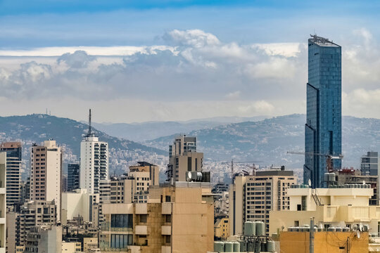 Beirut skyline showing the tallest building in the city, Sama Beirut, with mountains in the background