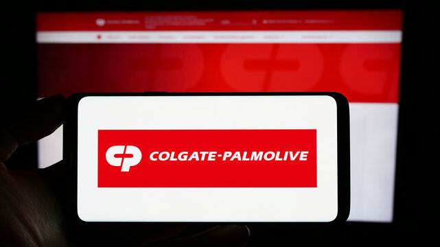 Stuttgart, Germany - 06-25-2023: Person holding cellphone with logo of consumer goods business Colgate-Palmolive Company on screen in front of webpage. Focus on phone display.