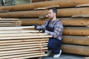 Joiner in uniform check boards on timber mill