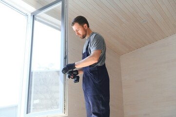 A worker installs windows in a new modular home. The concept of a new home.