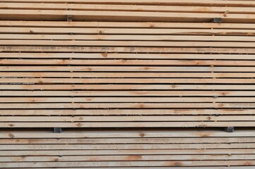 stacked wooden boards in a woodworking industry. stacks with pine lumber. folded edged board. wood harvesting shop. timber for construction.