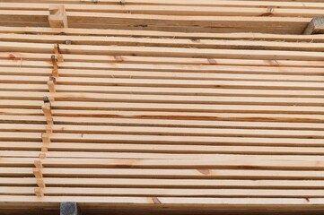 Wooden planks and beams. Air-drying timber stack. Wood air drying. Wood for house construction. Building material. Wood warehouse.