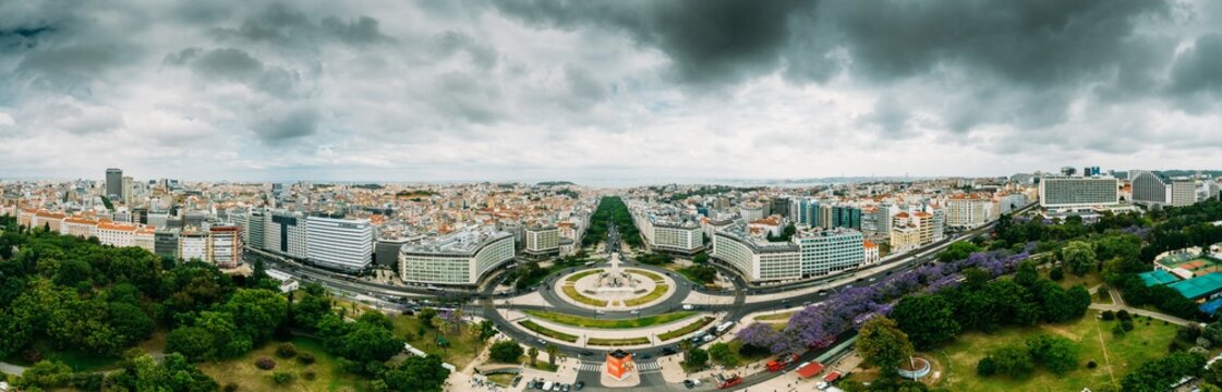 Aerial drone panoramic view of Parque Eduardo XII and Marques the Pombal looking south with Avenida da Liberdade in Lisbon, Portugal