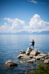 Fototapeta na wymiar Young teen on a rock at Lake Tahoe