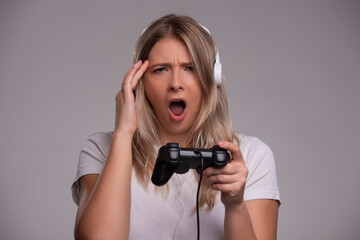 Woman playing video games with hand on head, headache because stress