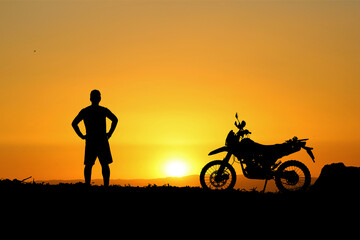 Fototapeta na wymiar Man with motocross bike against beautiful lights