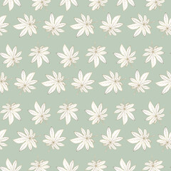 Beautiful seamless tropical pattern with golden leaves on a pale green background. Pattern for textiles, wrapping paper, wallpapers, backgrounds, decor.