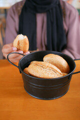  women hand pick a slice of whole grain bread 