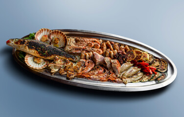 Tray with mixed grilled fish and vegetables