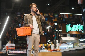 Handsome man shopping in a supermarket
