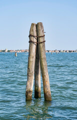 Vertical thick wooden posts called bricole (Venice bricola) on the Grand Canal in Venice