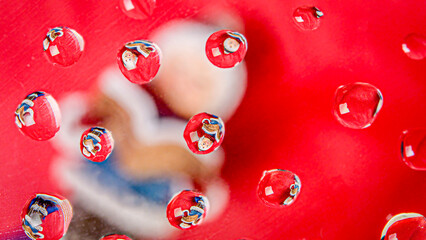 Water droplet of Christmas carollerr on a red background