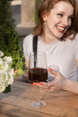 Smiling young woman drink filter coffee from wineglass
