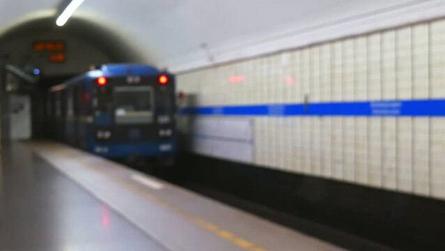 A blurry image of a moving train in the subway. Blurred background, urban, underground transport