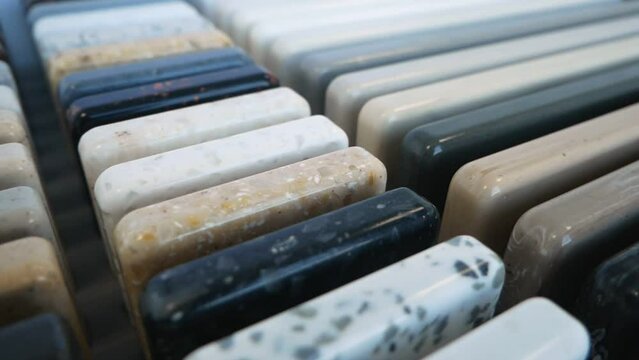 Sample of artificial acrylic stone for kitchen countertops and other furniture. Stone texture for modern interior design. Furniture production. Slow motion