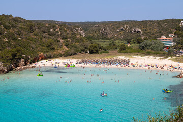 Fototapeta na wymiar Beach of the village of Cala en Porter on the Spanish island of Menorca.