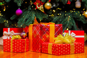 Fototapeta na wymiar Pile of Christmas gift boxes on the floor under beautiful Christmas tree
