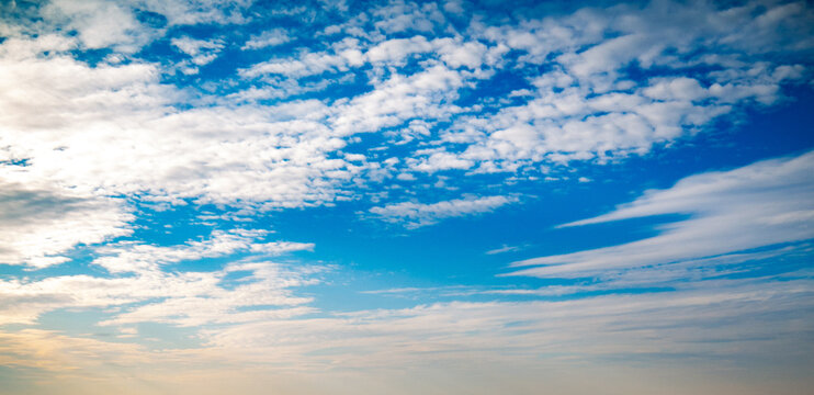 Blue sky with variety of clouds at all altitudes shot at 28 mm focal length