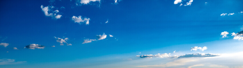 Blue sky with sparse clouds shot at 28 mm focal length