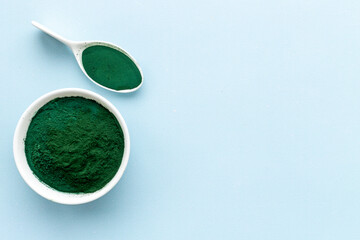 Dietary supplement for vegan Spirulina algae powder in bowl, top view