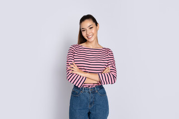 Beautiful young hispanic woman posing on grey studio background