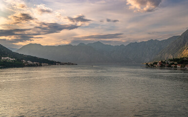 Landscape Exposure done from a cruise ship at sunset, showing the sea entrance to Kotor bay and its beautiful coastal landscapes and small villages , on a sunshiny day.