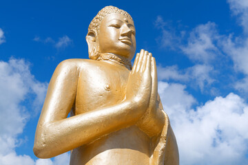 Golden Buddha against blue sky