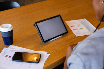 Plus size african american casual businesswoman making video call using tablet, copy space in office