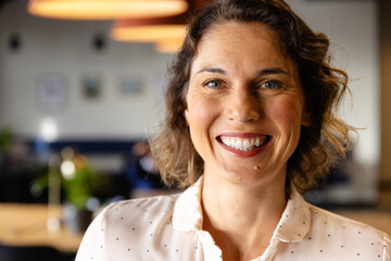 Portrait of happy caucasian casual businesswoman in office