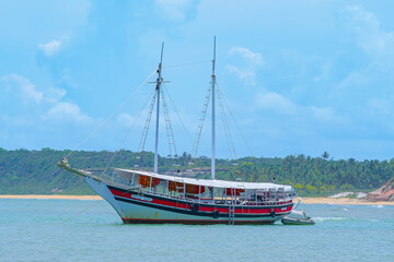 A big tourist boat on the sea of Espelho Beach, a beautiful beach of Porto Seguro at Bahia state.
