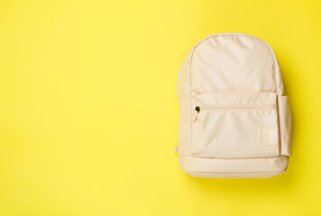 Pink school backpack on color background, top view