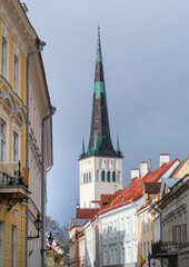 The bell tower of the Church of St. Olaf. Tall beautiful spire of the church. Tallinn, Estonia