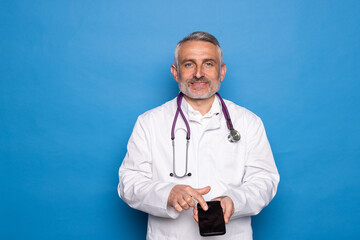 Portrait of male doctor with clipboard isolated on color background