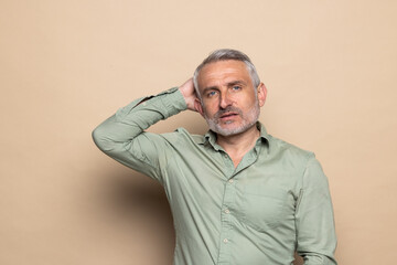 Fototapeta premium Portrait of attractive cheerful man folded arms making decision isolated over beige pastel color background