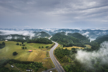 Road, highway across foggy mountains in Tennessee. Little Sycamore, Tennessee empty highway. - 620327865
