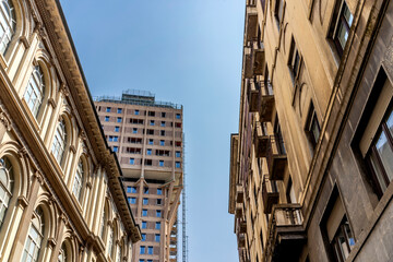 A street of Milan city center with Torre Velasca in the background, in Milan, Lombardy region, Italy