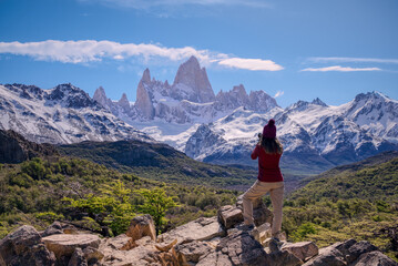 Woman on the point view photographing Mount Fitz Roy