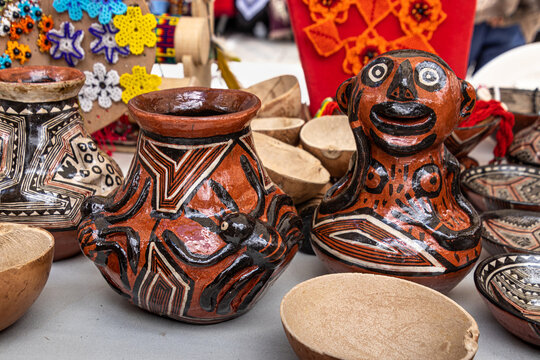 Pottery craft of Quechua women from the Ecuadorian Amazon region, the city of Puyo. Jugs and bowls with traditional paintings and depictions of jungle animals.	