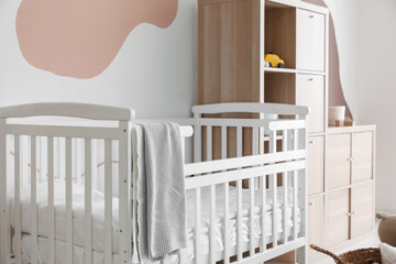 Interior of children's bedroom with bed and shelving unit
